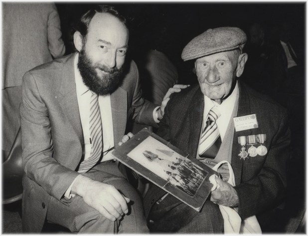 Leo de Saxe looking back at the photo taken of him when he was a young soldier in Egypt in 1915 - a long way from Moruya!